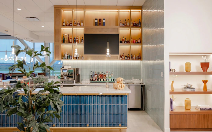 Bar area at Plaza Premium First lounge, Vancouver International Airport, featuring liquor display and seating.