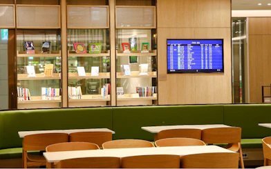 Bar seating and flight information screen at Plaza Premium Lounge, South Korea.