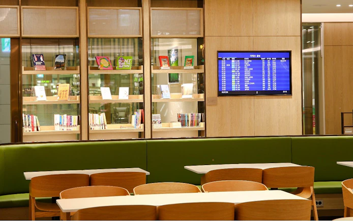 Bar seating and flight information screen at Plaza Premium Lounge, South Korea.