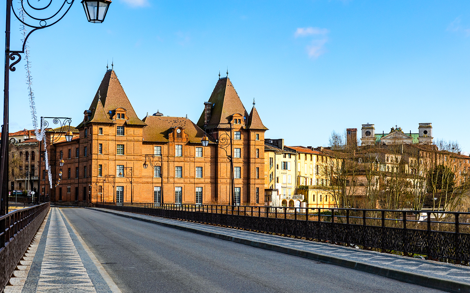I don't know who this is, but the image shows a historic building with towers and a bridge in the foreground.