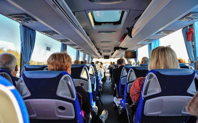 Tourists seated inside a bus on the Florence to Cinque Terre guided tour.