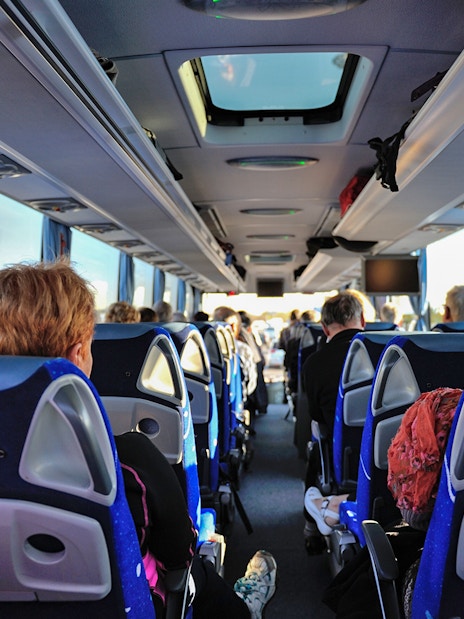 Tourists seated inside a bus on the Florence to Cinque Terre guided tour.