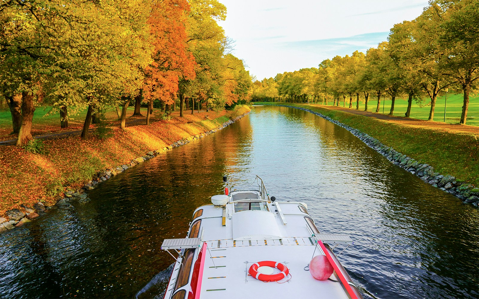 Cruise boat navigating Djurgrden City Canal in Stockholm, Sweden.