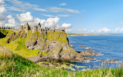 Dunluce Castle ruins on a cliff overlooking the North Atlantic Ocean in Northern Ireland.