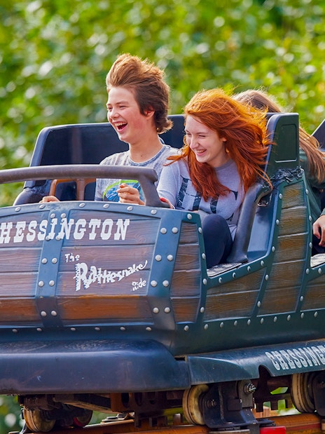 Riders enjoying the Rattlesnake roller coaster at Chessington World of Adventures.