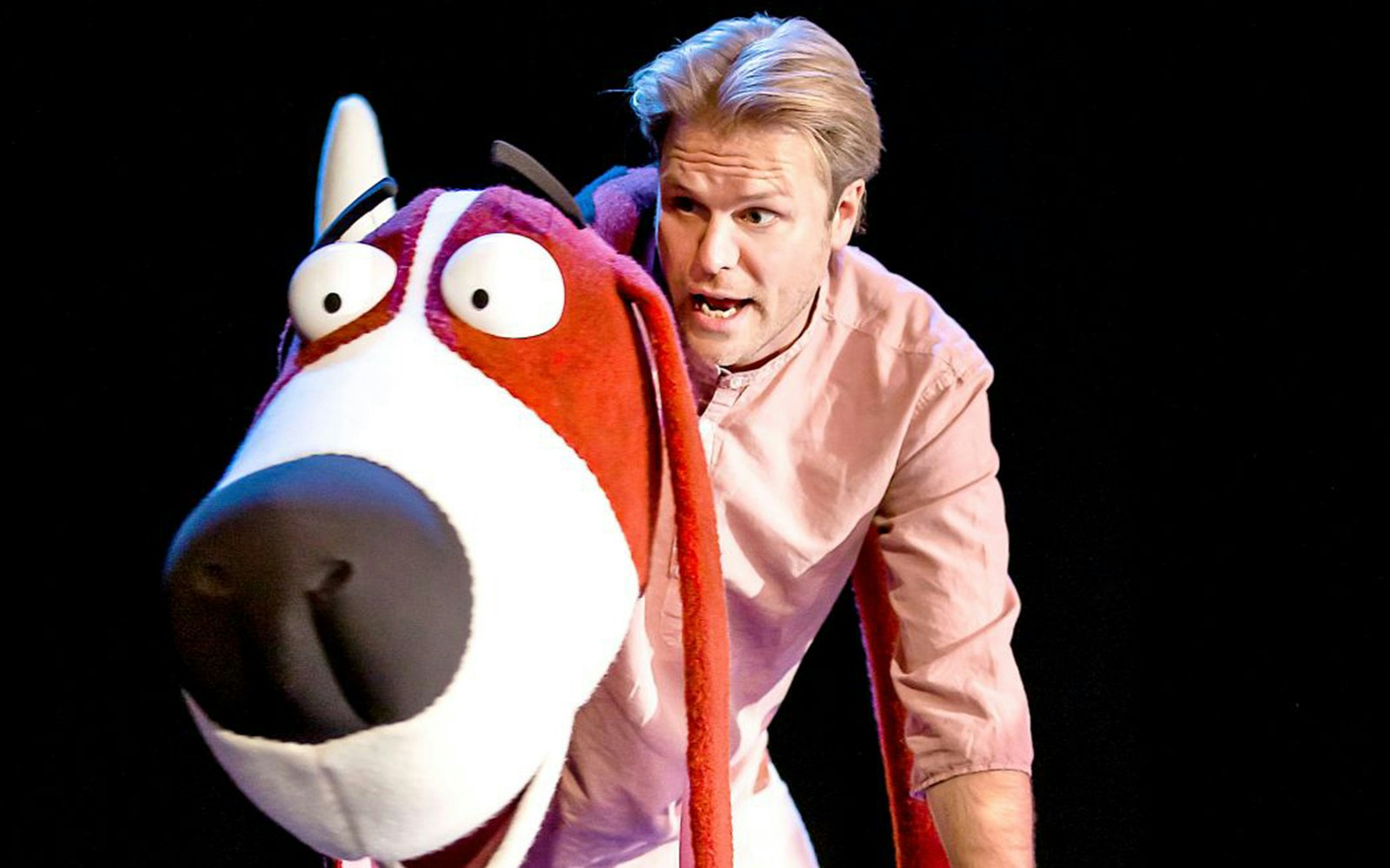 Performer with large dog puppet in "Oi Frog & Friends!" show.
