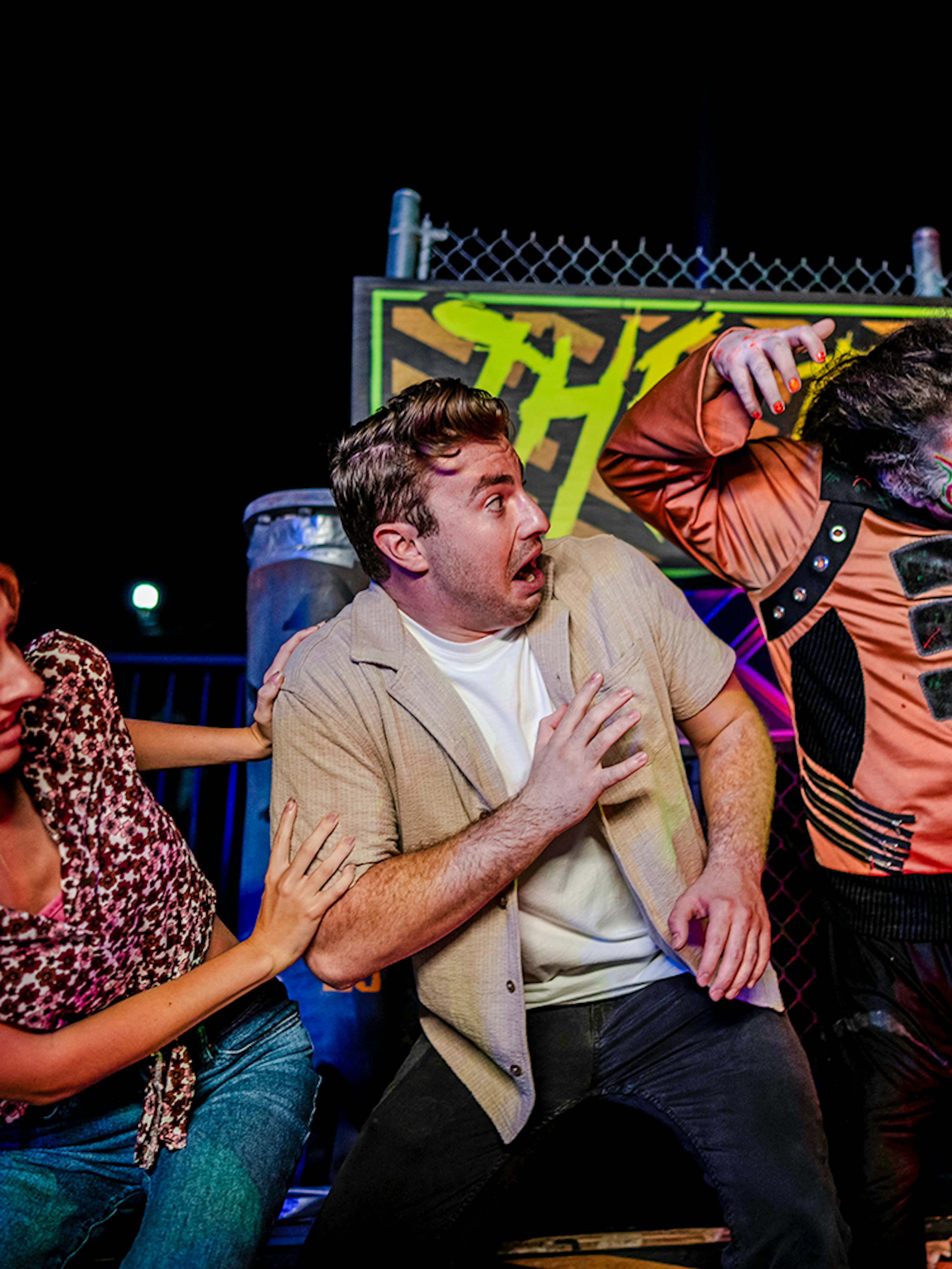 Guests reacting to a costumed performer in Halloween Haunt zone at Dorney Park.