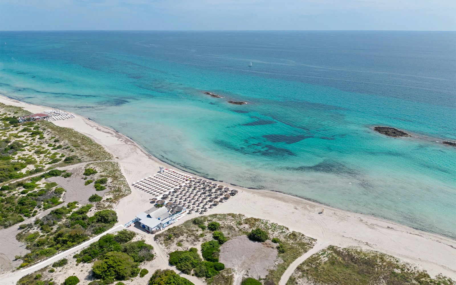 Panoramic view of Maria Pia Bay and San Giovanni Beach with turquoise waters and sandy shoreline.