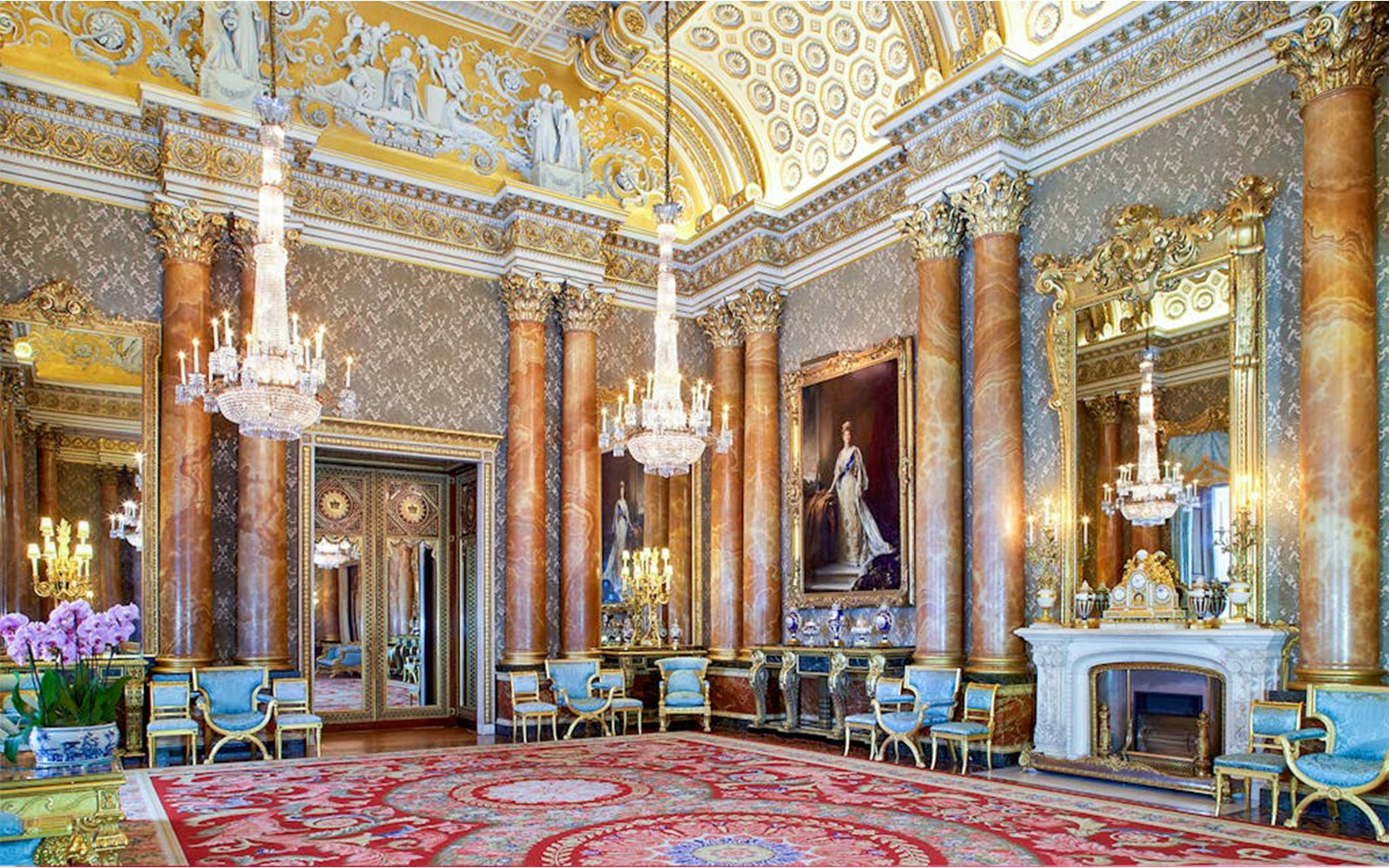 Buckingham Palace State Room with ornate chandeliers and regal decor.