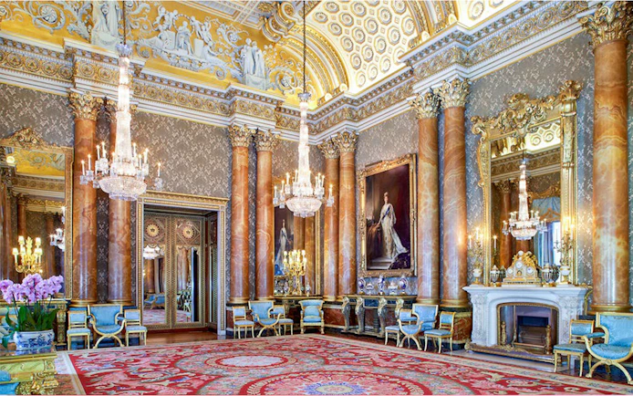Buckingham Palace State Room with ornate chandeliers and regal decor.