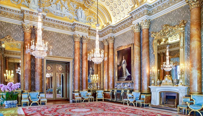 Buckingham Palace State Room with ornate chandeliers and regal decor.