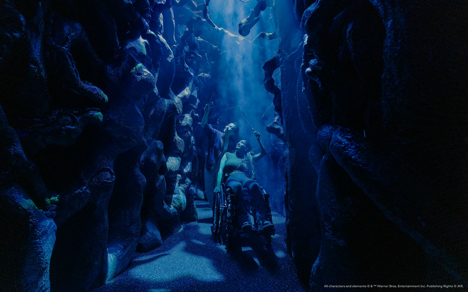 People exploring a magical maze with wands, part of the Harry Potter Visions of Magic tour.