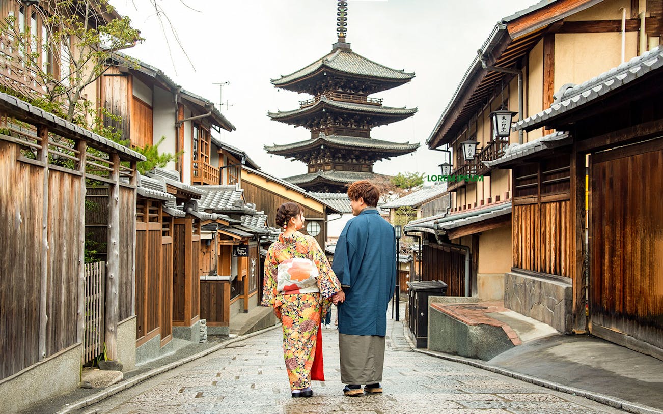 Couple in traditional attire walking towards Yasaka Pagoda, Kyoto.