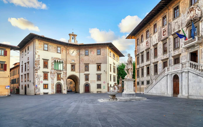 Pisa's Knights' Square with historic buildings and statue, part of a self-guided city exploration game.