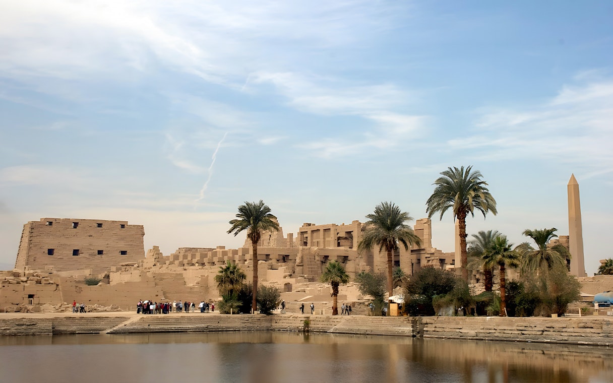 Karnak Temple complex with palm trees and obelisk, Luxor, Egypt.