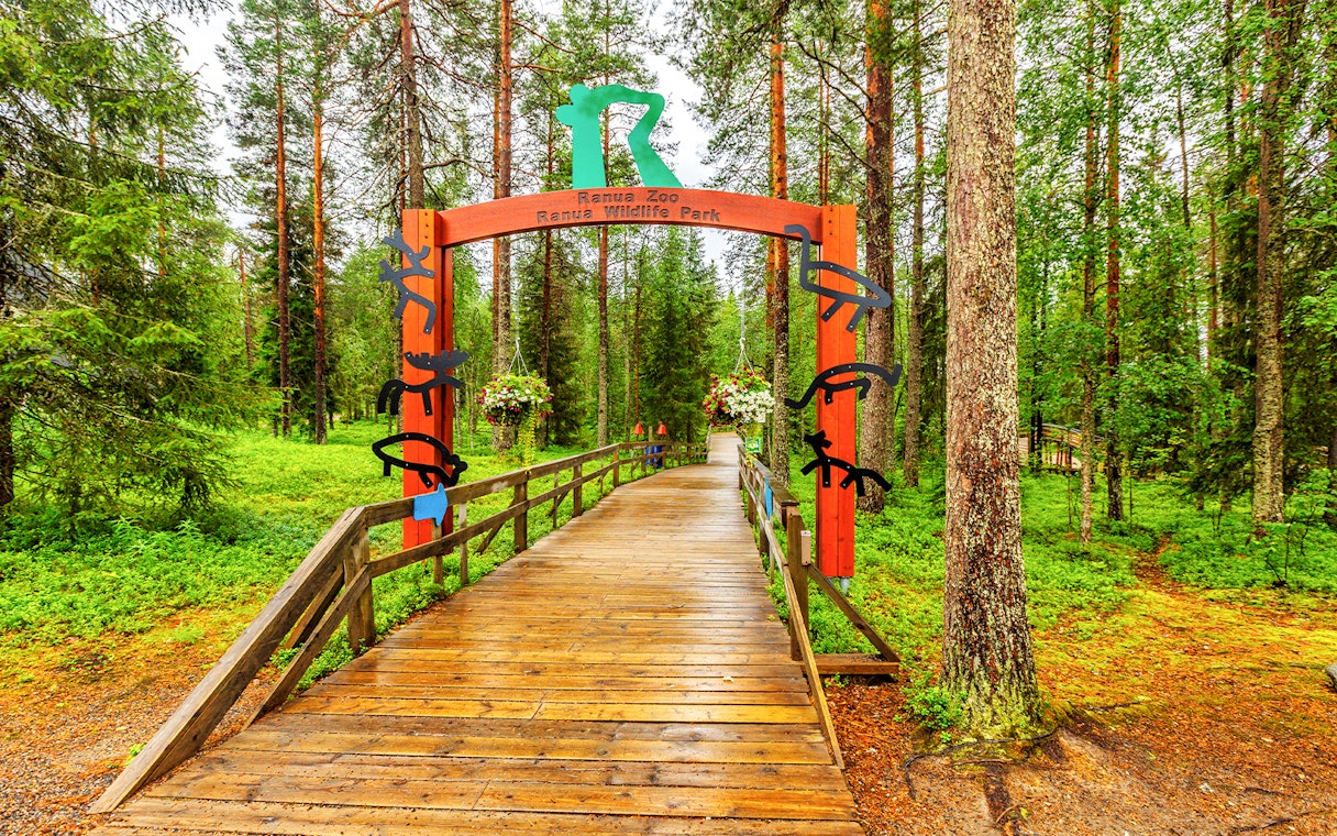 Ranua Wildlife Park entrance with wooden walkway and forest backdrop.