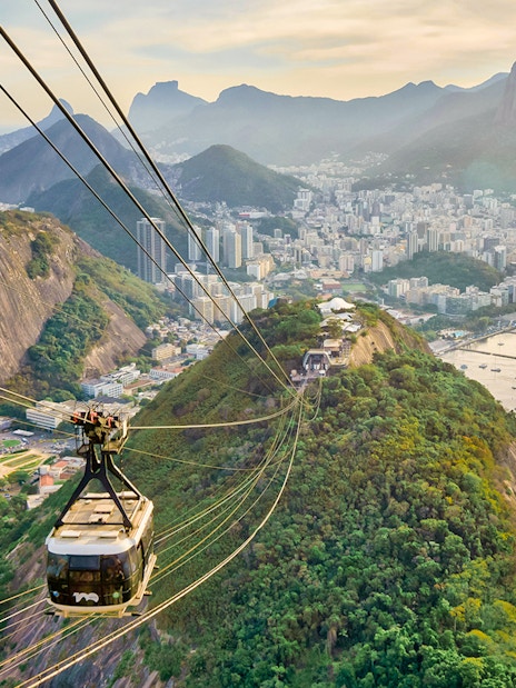 Cable car descending from Sugarloaf Mountain, Rio de Janeiro, with city and ocean views.