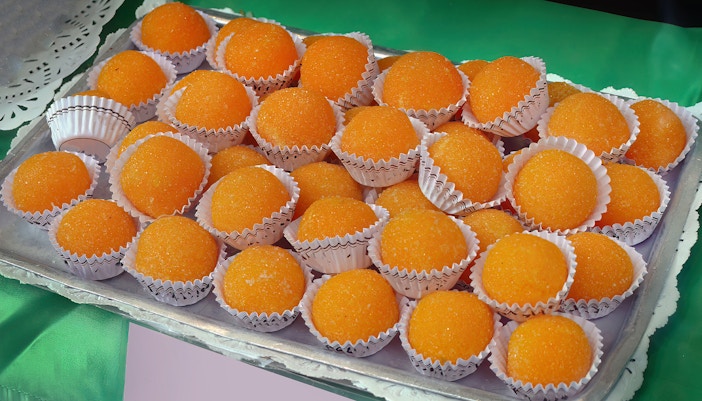 Yemas de Santa Teresa sweets displayed on a tray in Ávila, Spain.