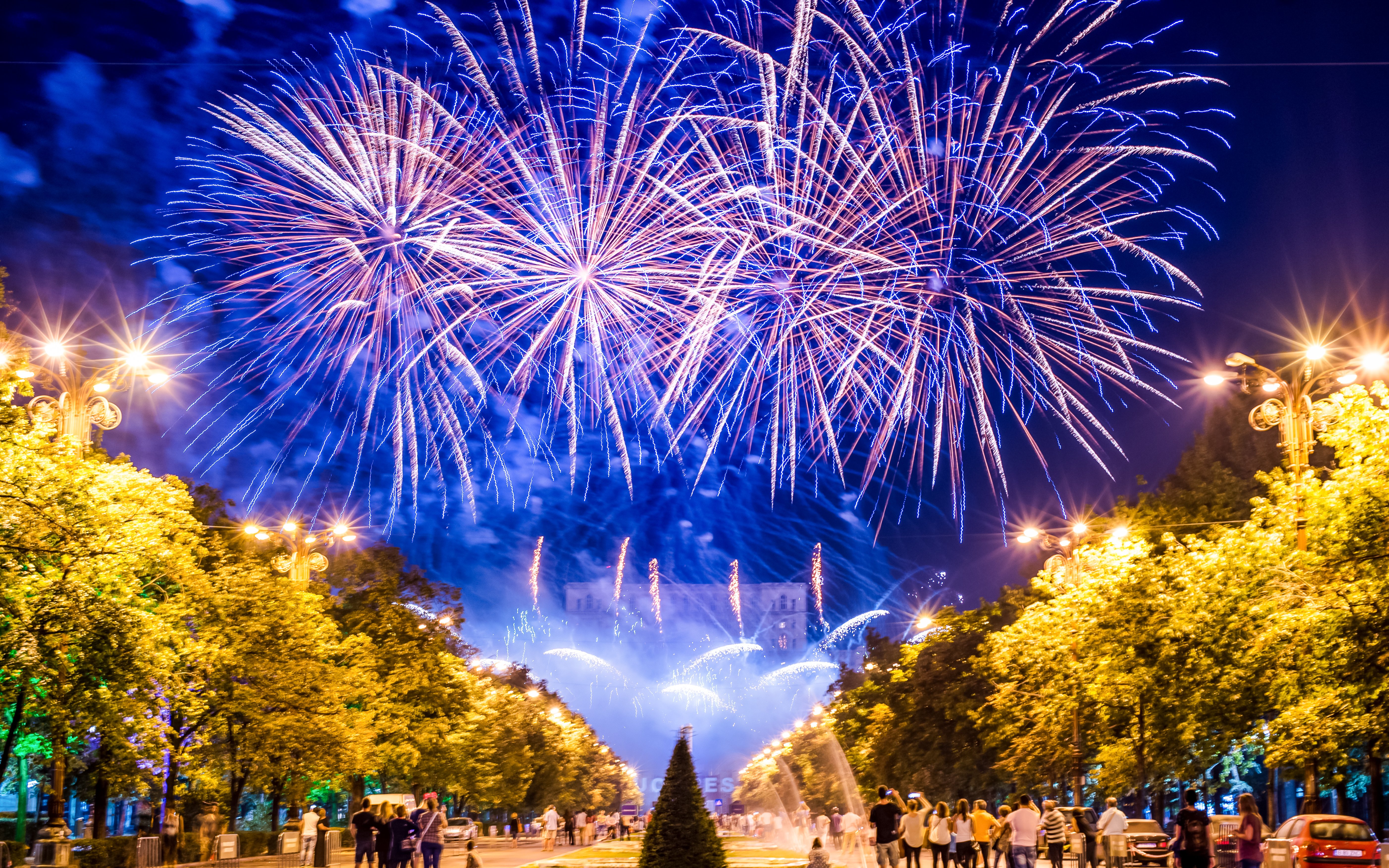 Fireworks display at Centennial Olympic Park with people watching below.