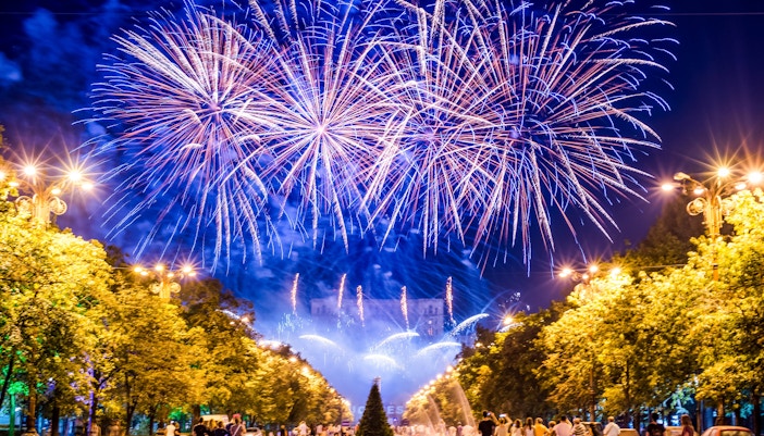 Fireworks display at Centennial Olympic Park with people watching below.