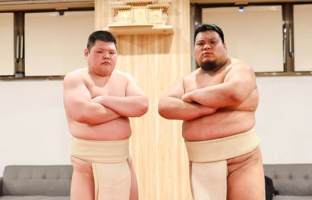 Sumo wrestlers posing at Shibuya Sumo Show in Tokyo.