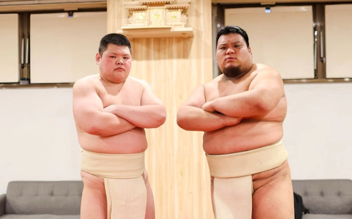 Sumo wrestlers posing at Shibuya Sumo Show in Tokyo.