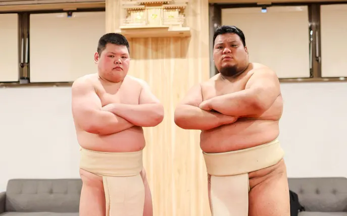 Sumo wrestlers posing at Shibuya Sumo Show in Tokyo.