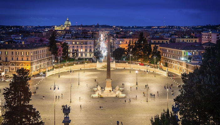 Piazza del Popolo illuminated at night with the obelisk in Rome, Italy.