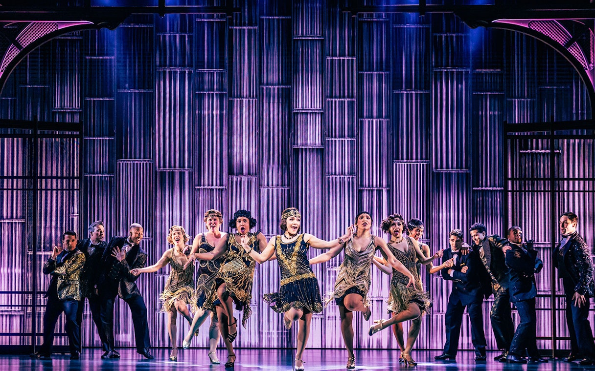 Performers in 1920s attire dancing on stage during The Great Gatsby show.