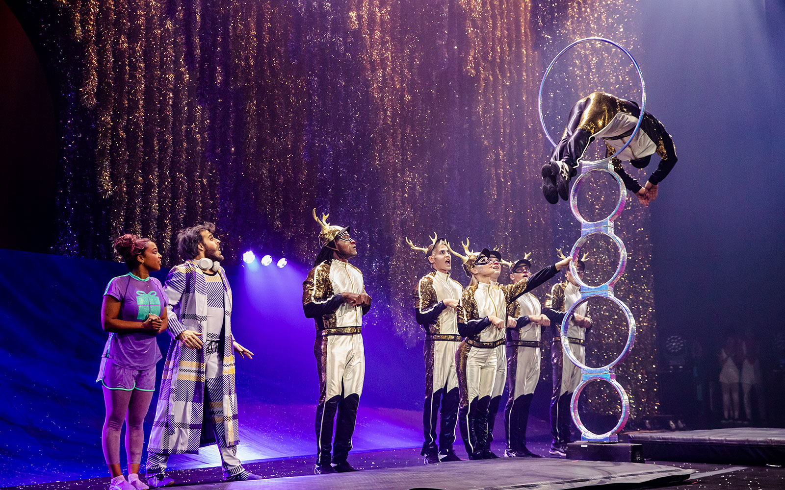 Acrobats performing a hoop jump in Cirque du Soleil's 'Twas The Night Before stage show.