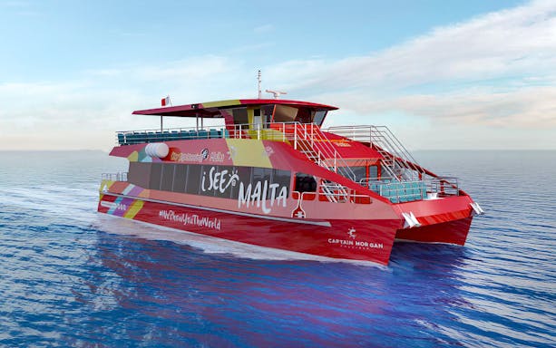 Red sightseeing boat on Malta's waters for hop-on hop-off tour.