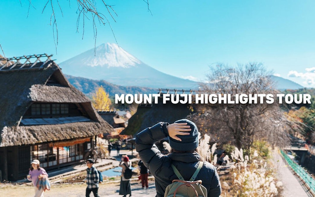 Traveler viewing Mount Fuji from a traditional Japanese village, Tokyo MegaPass tour.