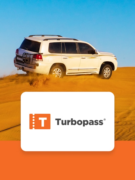 SUV driving on Dubai desert dunes, part of Dubai City Pass experience.