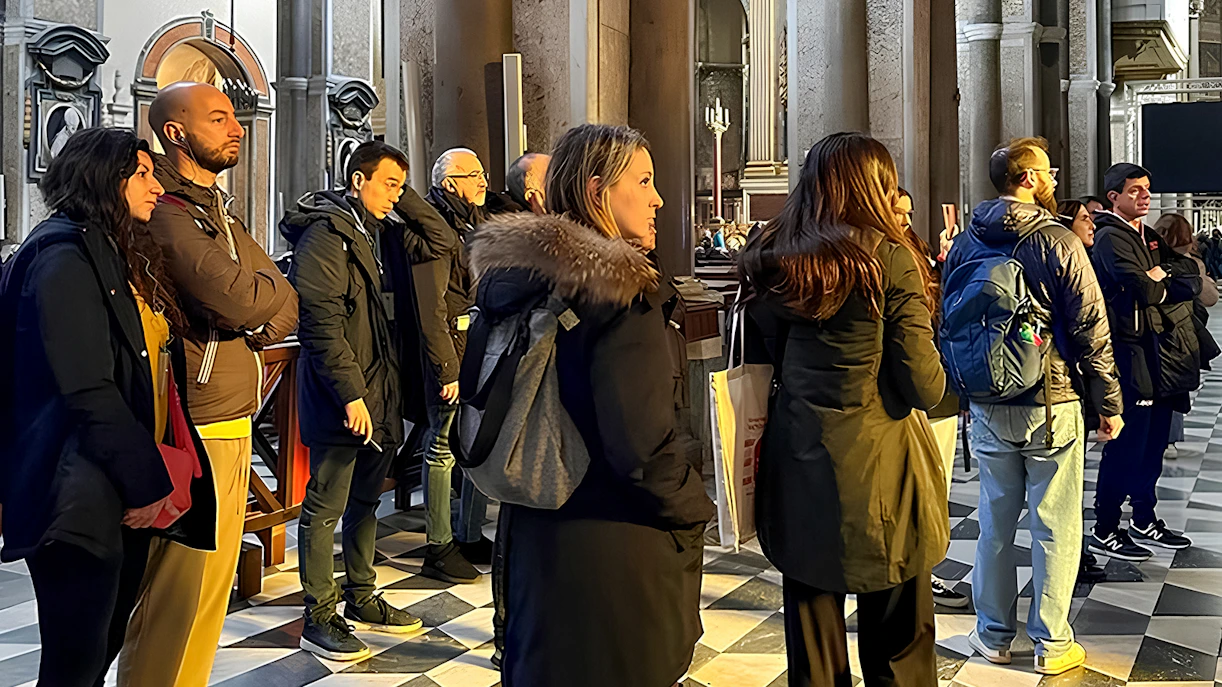 Visitors listening to a historian inside Sansevero Chapel, Naples.