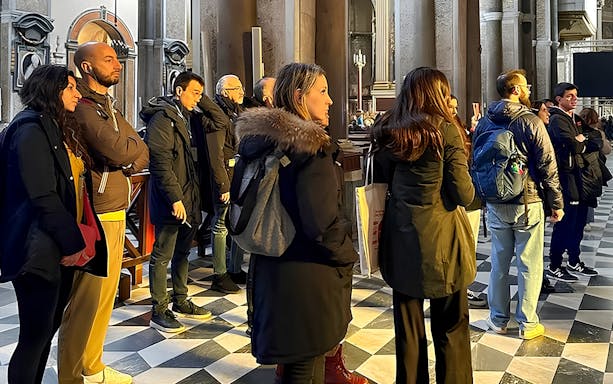 Visitors listening to a historian inside Sansevero Chapel, Naples.