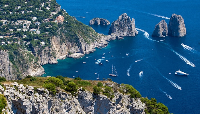 Capri coastline with Faraglioni rock formations, Italy.