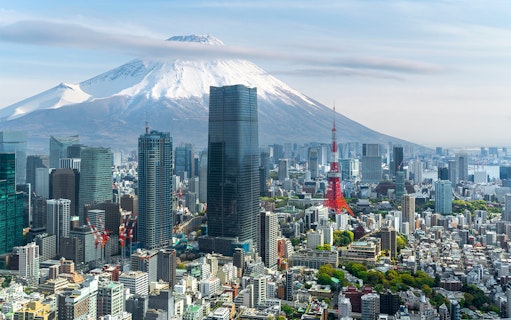 Tokyo skyline with Tokyo Tower and Mount Fuji in the background.