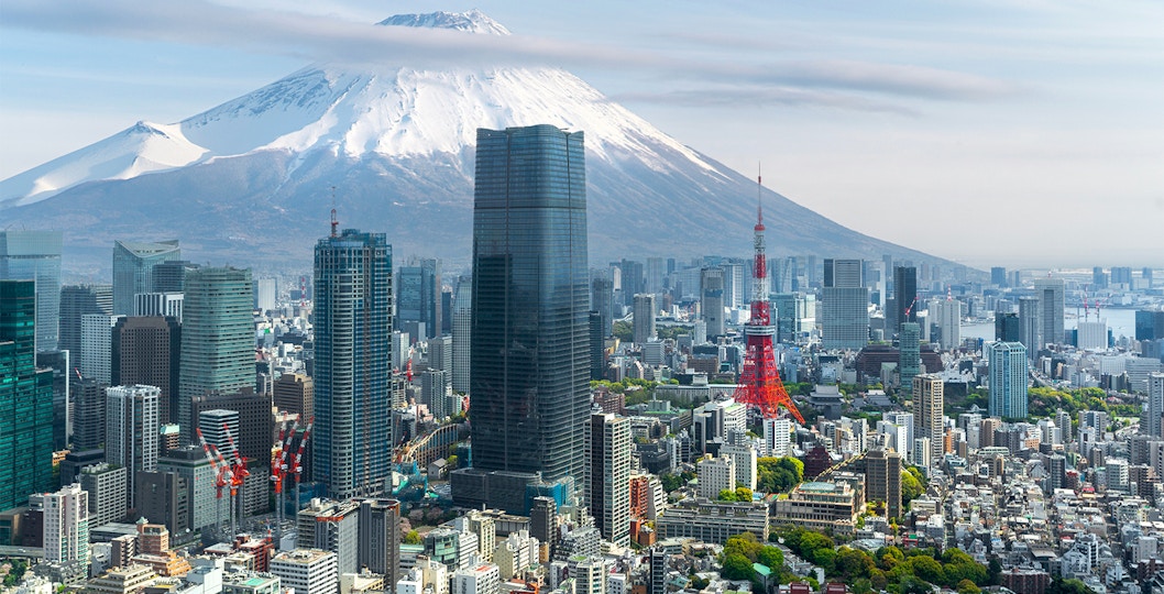 Tokyo skyline with Tokyo Tower and Mount Fuji in the background.