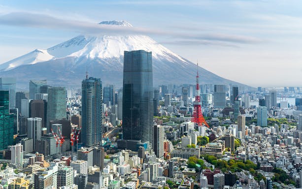 Tokyo skyline with Tokyo Tower and Mount Fuji in the background.