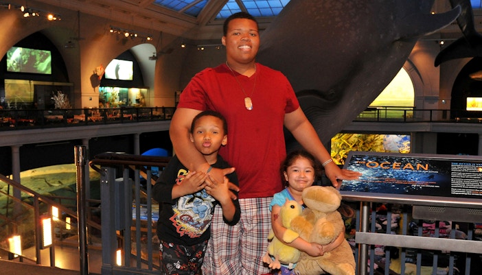 Children and families enjoying a sleepover at the American Museum of Natural History.