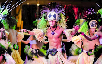 Dancers in traditional attire performing at Luau Kalamaku, Hawaii.