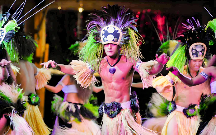 Dancers in traditional attire performing at Luau Kalamaku, Hawaii.