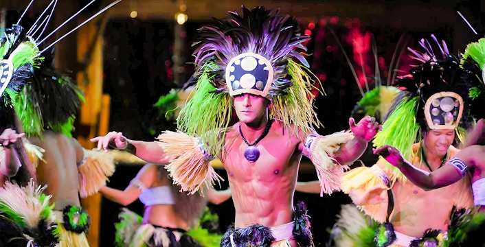 Dancers in traditional attire performing at Luau Kalamaku, Hawaii.