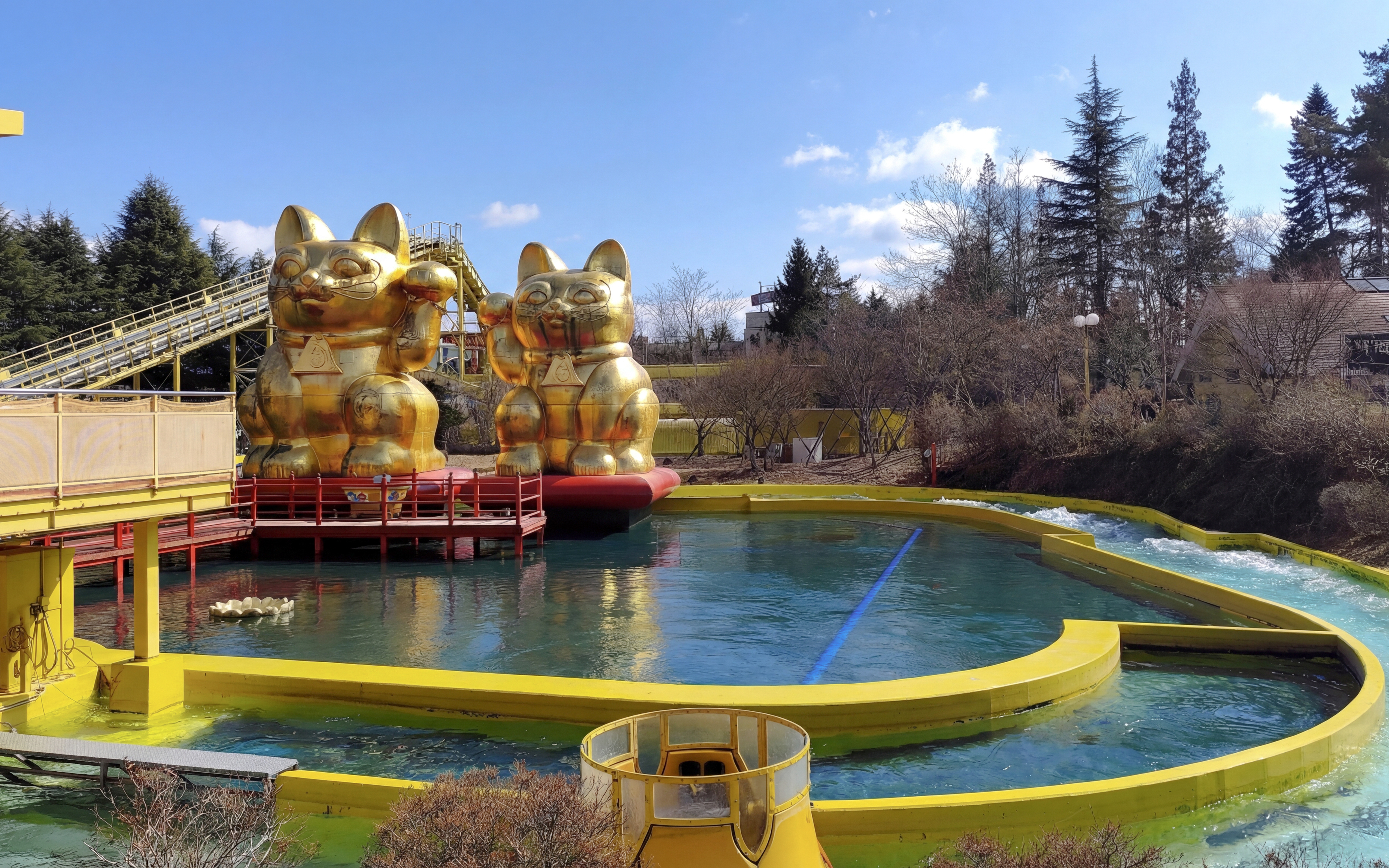 Nagashimasuka water ride with golden cat statues at Fuji-Q Highland, Japan.