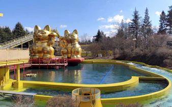 Nagashimasuka water ride with golden cat statues at Fuji-Q Highland, Japan.