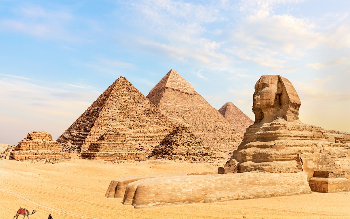 Pyramids of Giza and Great Sphinx under clear sky in Giza, Egypt.