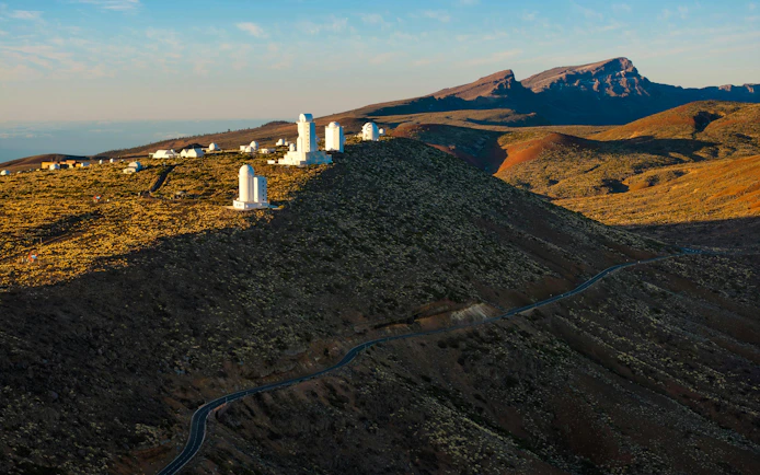 Teide Observatory at sunrise with mountainous landscape, Tenerife.