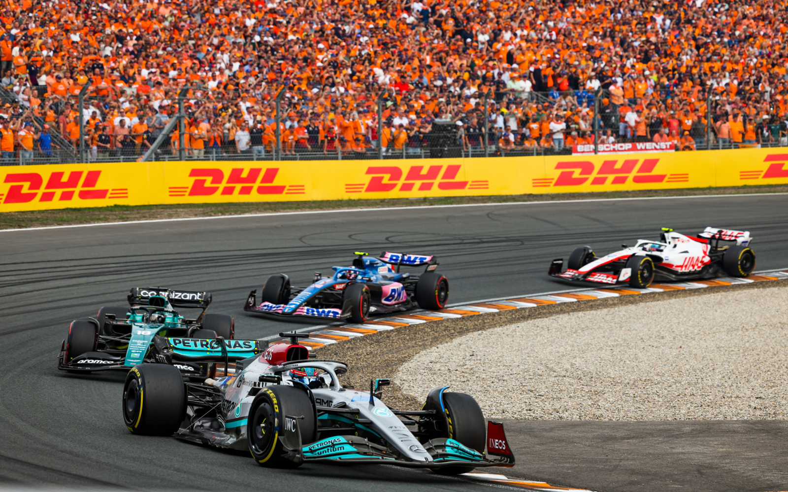 Formula 1 cars racing at Dutch Grand Prix, Zandvoort, with crowd in orange.