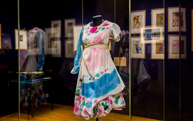 Colorful costume display at Opéra Garnier exhibit in Paris.