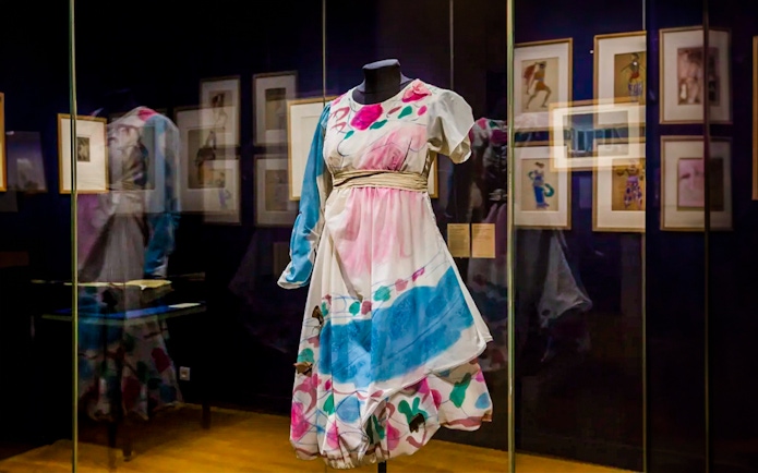 Colorful costume display at Opéra Garnier exhibit in Paris.